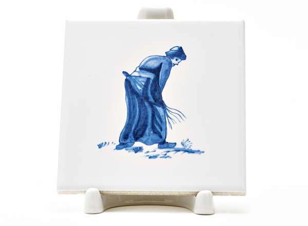 Tile Dutch. Woman with a broom 